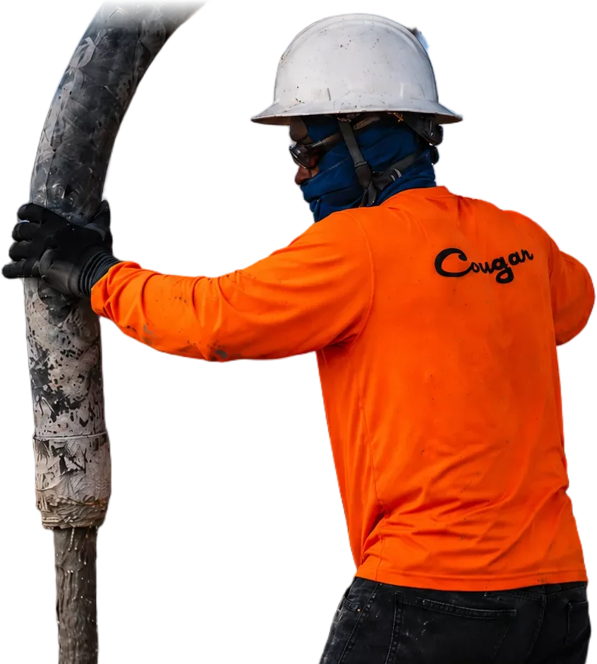 Cougar Companies crew member guiding a concrete pump hose